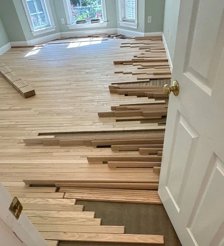 Hardwood floor being installed in a bay window room with stagger pattern pre-layout